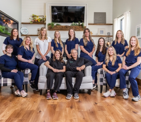 Three smiling dental team members