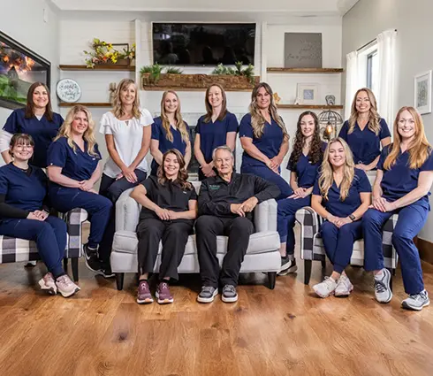 Three smiling dental team members