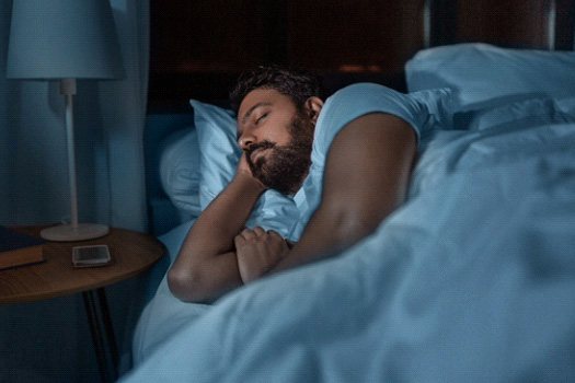 Man sleeping on his side in bedroom