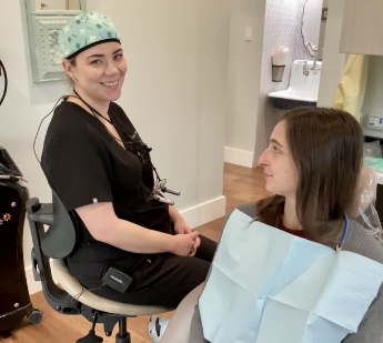 Doctor Eide smiling while talking to a patient in the treatment chair