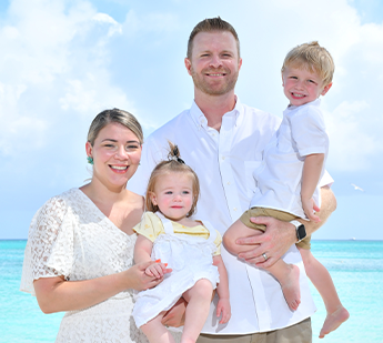 Doctor Eide with her husband and two young children at the beach