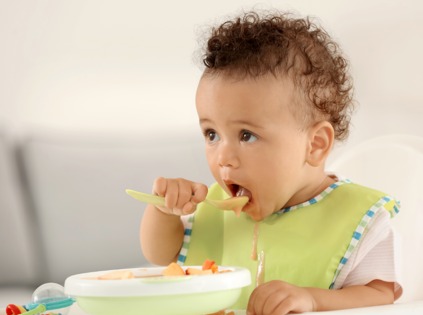 Baby eating out of bowl