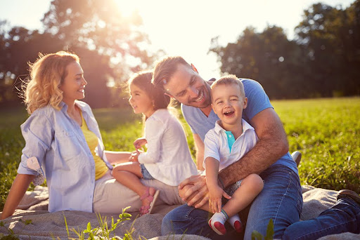 young family enjoying the sunny weather at the park